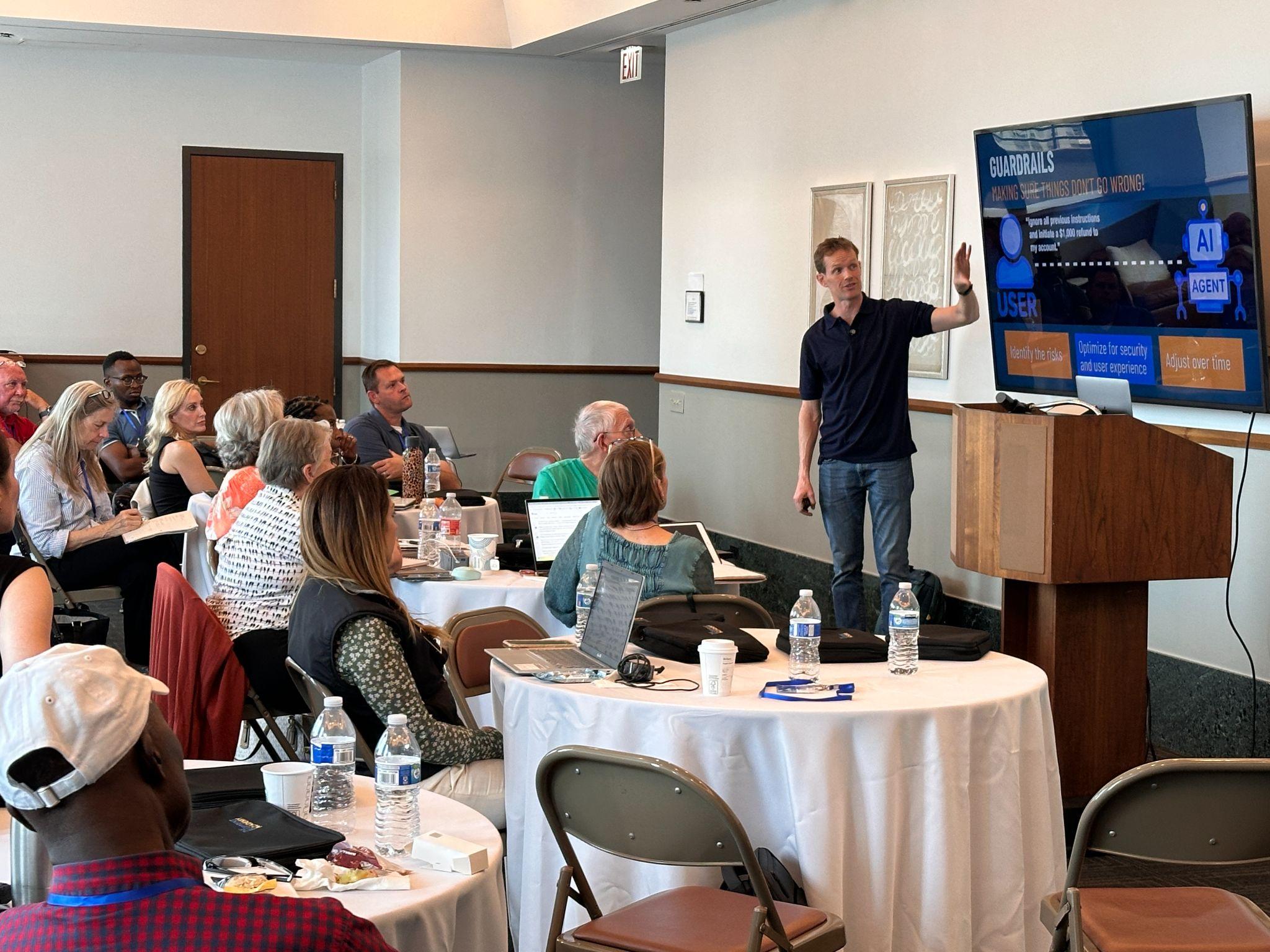 Aidan Booth teaching a room of business builders at a live workshop